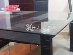 Dining table with eight leather chairs for sale in Qatar